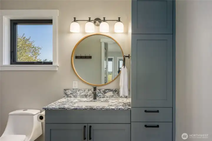 Bathroom off the bedroom with custom cabinets.