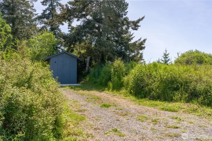 Storage shed half way down the driveway.