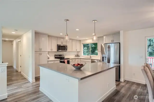 Unleash Your Inner Chef In the Stunning Open Concept Kitchen Boasting Updated Cabinets, Quartz Countertops and Stainless Steel Appliances