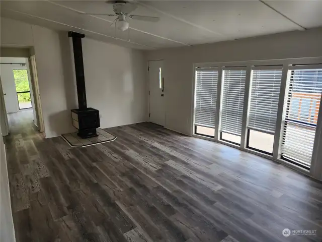 Living room with floor to ceiling windows and wood burning fireplace for our upcoming cold winter days