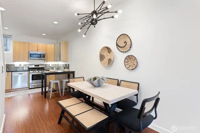 A seamless transition from the dining to the south facing kitchen with Eco-friendly countertops by Cosentino and high-end Bosch and Fisher & Paykel stainless appliances.