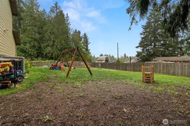 Huge yard is fully fenced and ready for play, gardening or entertaining.