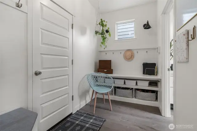 The mud room with storage is just off the garage, the powder room is to the right.