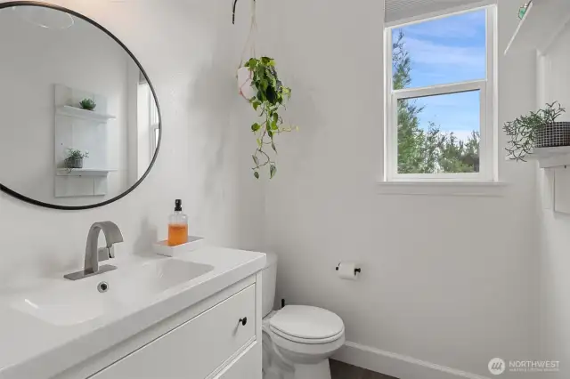 Main floor powder room is located off the mud room.  Updates here include the vanity and mirror.