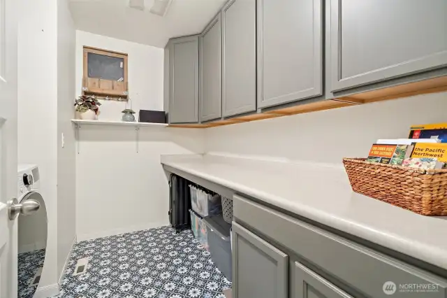 The laundry room (located upstairs with the bedrooms) has added cabinetry for extra storage.