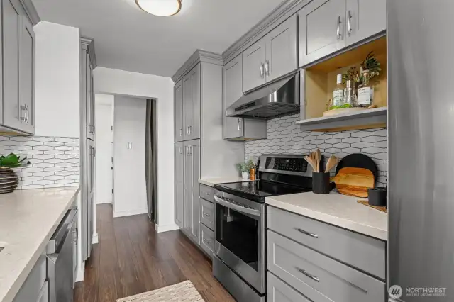 Thoughtful storage and sleek finishes define this kitchen crafted for both quiet mornings and effortless hosting.
