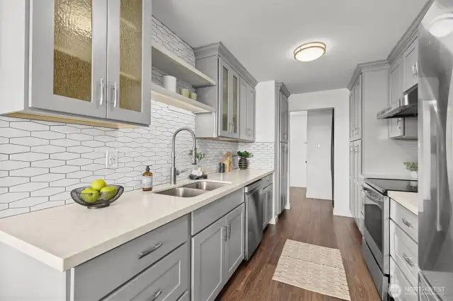 From the galley kitchen, looking toward the entry and showcasing the thoughtful flow and seamless design throughout the home.