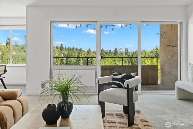 Expansive windows frame lush treetops and iconic Mt. Rainier. Bringing the outdoors in and giving your new living space a front row seat to the view.