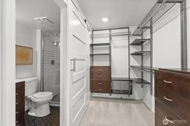 The spacious walk-in closet connects to a refreshed en suite bath offering smart storage, sleek finishes, and everyday ease.