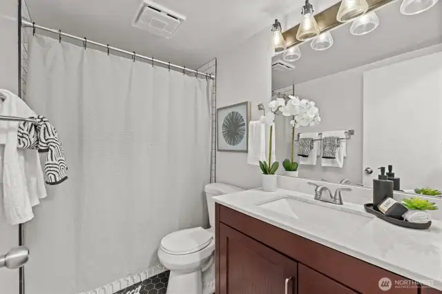 The full hallway bath is crisp and stylish, with updated fixtures, a full tub-shower combo, and clean finishes.