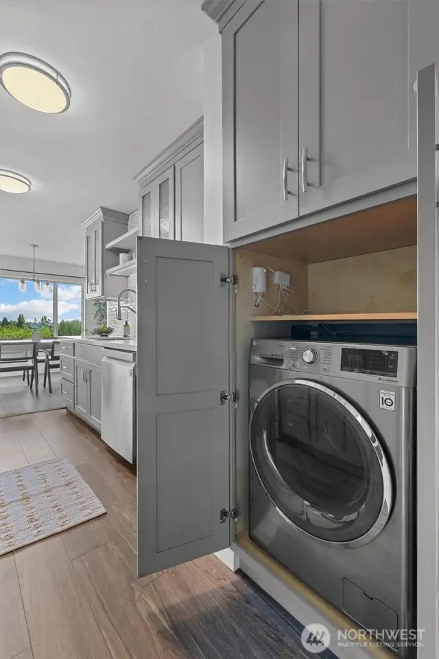 Tucked into the sleek custom cabinetry, you'll find a hidden combo washer/dryer for convenience and compatibility.