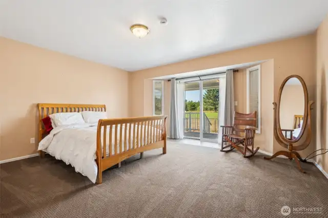 Primary bedroom overlooks the golf course with a sliding door to the back deck.