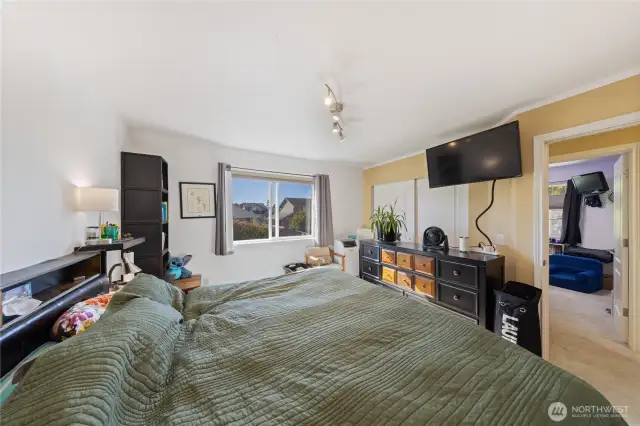 This photo shows the Primary Bedroom.  You can see the second child's bedroom through the doorway.  The Primary Bathroom is located to the right of this picture.