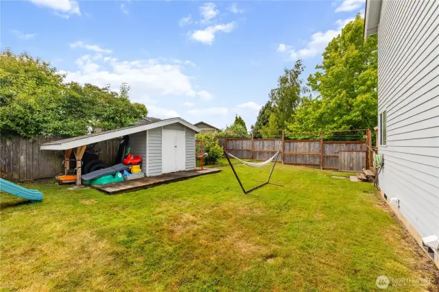 Large fully fenced back yard.  The Garden shed is perfect for storage.  The deck is behind the home on the right.