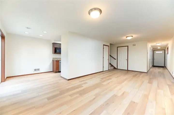 sweeping main floor entry into large living room flowing right into dining space and kitchen