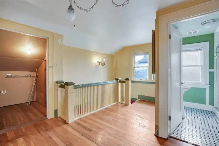 Beautiful staircase railing and hardwood floors highlight the upper level.