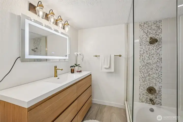 Full bathroom complete with Tub and Tiled Shower