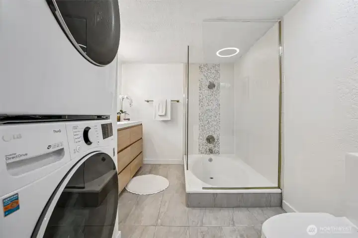 Stacking Front Load Washer & Dyer located in the Bathroom