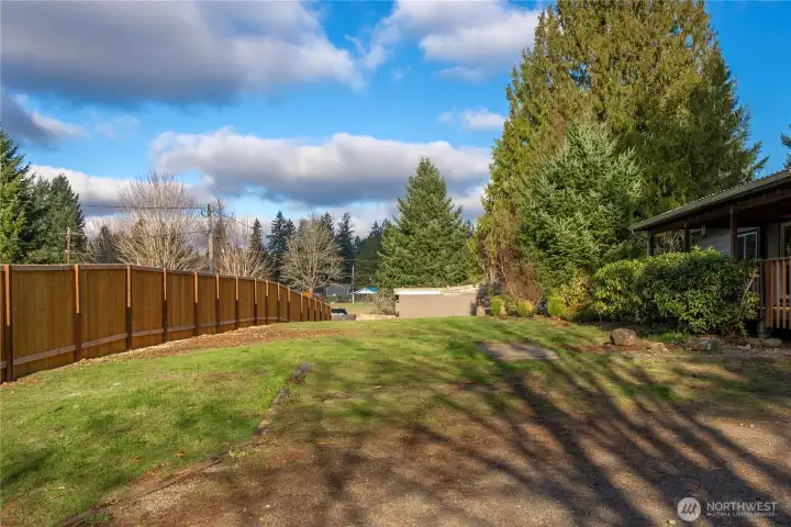 Large front yard enhanced by a newly installed cedar fence, adding both privacy and a polished, updated look.