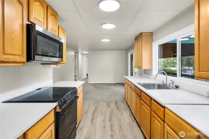 Spacious open-concept kitchen offers NEW LVP FLOORING, excellent flow, abundant storage, and sightlines to adjacent living areas.