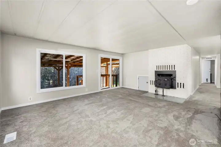 Bright living room highlights new windows throughout the home and updated exterior doors, enhancing light and connection to outdoor spaces.