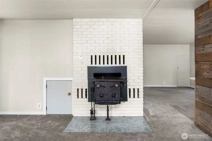 Cozy living room centerpiece features a wood-burning fireplace that adds warmth and character to the space.