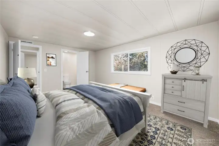 Comfortable primary bedroom offers a peaceful retreat with fresh finishes and ample space for furniture placement.  (photo virtually staged)