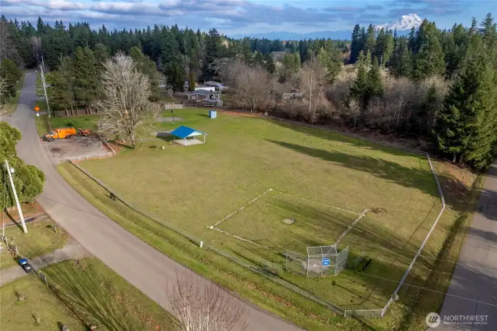 Aerial view of nearby Gehrke Park showcases expansive green space & recreation areas just steps from the home.