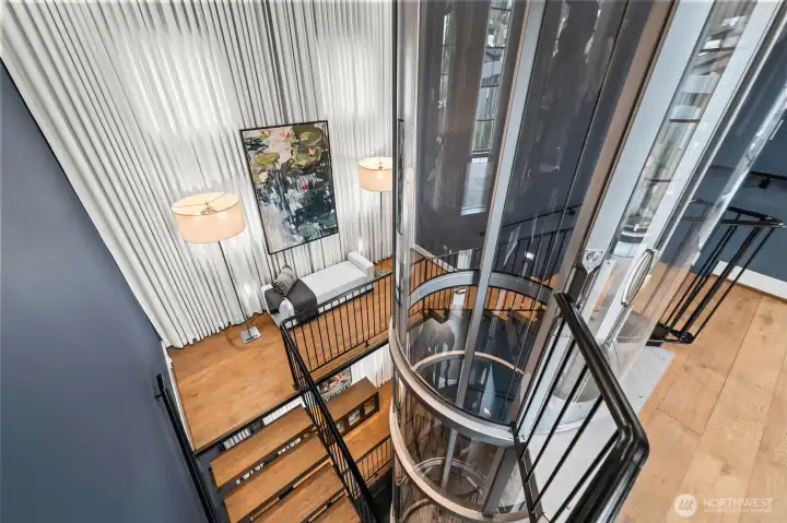 Ride in style. The glass cab offers shifting perspectives of the curated interiors and custom art walls as you glide between the three floors.