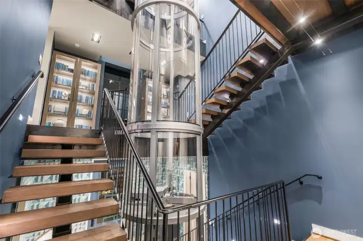 The transparent spine. Serving as the home's central artery, the elevator visually and physically connects the intimate living spaces without blocking light or flow.