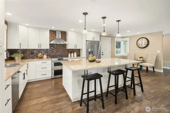 Fresh trim and craftsman doors, and LVP flooring throughout. Newer Milgard Tuscany vinyl windows, two-way blinds, newer 95% efficiency furnace and water heater. Newer outlets, fixtures and recessed lighting.