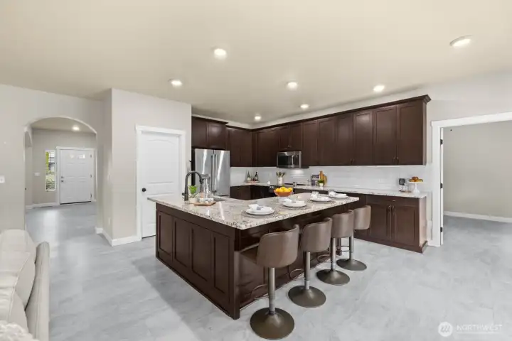 Huge island complete with granite counters & timeless cabinets