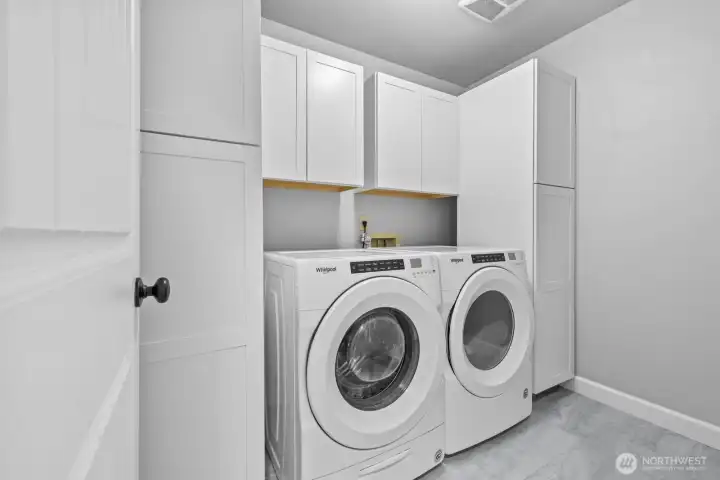Upstairs laundry room with built in cabinets