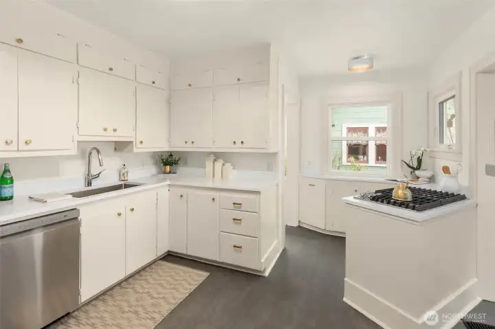 Kitchen has been refreshed with new quartz countertops, paint & floors and flows nicely into the living/dining area.