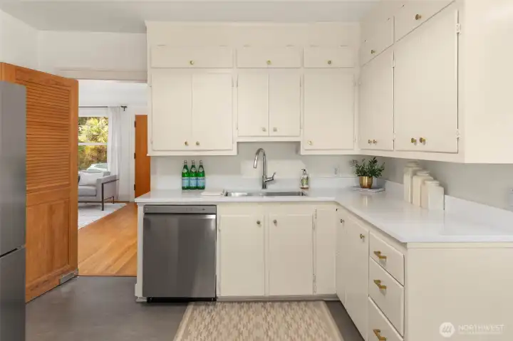 Kitchen has been refreshed with new quartz countertops, paint & floors and flows nicely into the living/dining area.