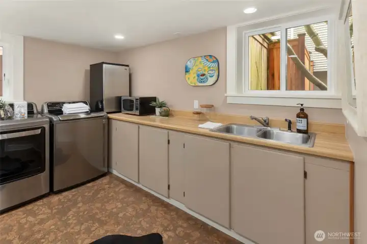 Lower level laundry area and kitchenette great space for great flexible space for a rec room, guest suite, or work-from-home setup.