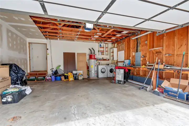 Two car garage interior. Laundry area in garage, washer/dryer included.
