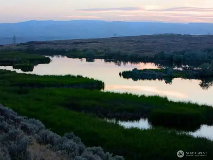 60 acres of lakes and ponds altogether:  Hilltop Lake (30 acres) spills over the 400 ft. high basalt cliff into a water fall.  Caliche Creek tumbles down alongside the Old Covered Wagon trail into the Coulee.