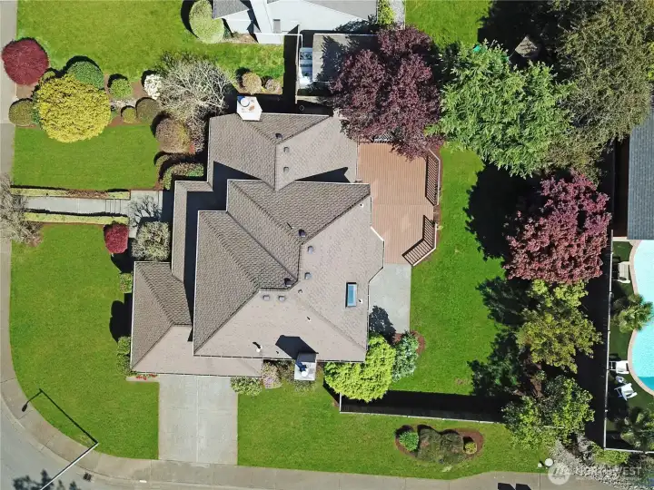 Spacious home with extensive landscaping, featuring multiple outdoor living areas and proximity to community amenities