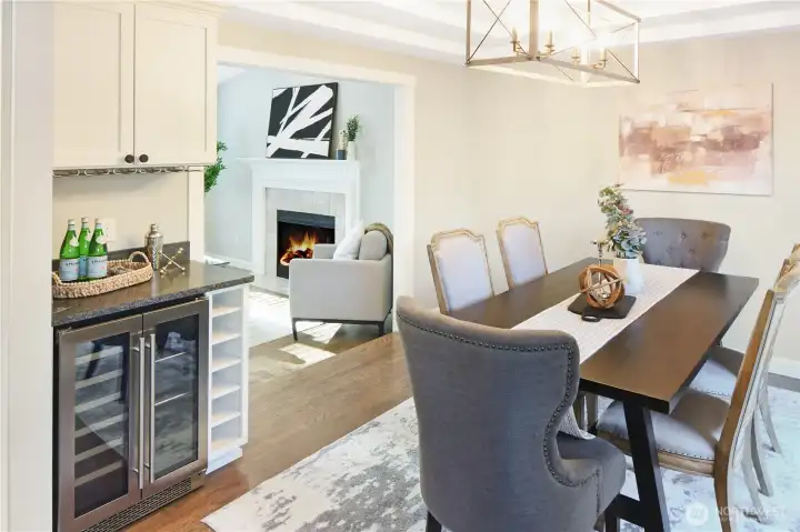 Bright dining area flows into a cozy living space. Wine fridge with raw edge granite counter adds elegance to impress your guests.