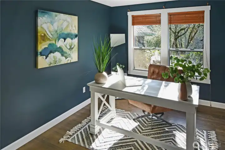 Bright home office featuring large windows and a calming color palette for productivity is on the main level.