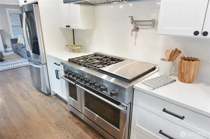 Enjoy the double oven and gas range with pot filling faucet. Chefs kitchen is ready for you.