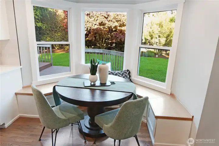 Sunny breakfast nook feels like part of the kitchen with a fun built in bench.