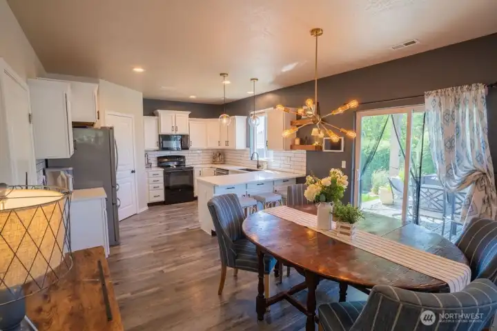 Dining area looking into large kitchen