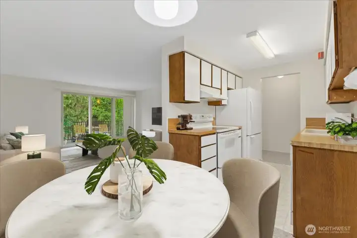 Virtually staged - Great view from the dining room out to the peaceful balcony.