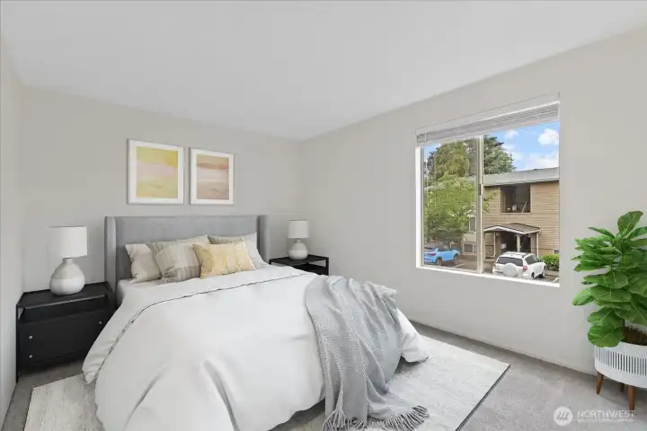 Virtually staged second bedroom with large window and generous closet.