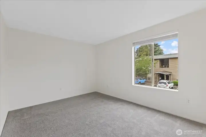 Second bedroom with large window and generous closet.