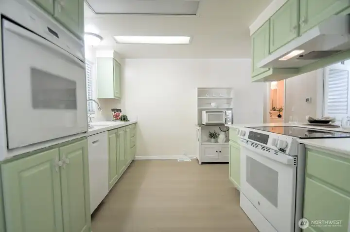 To the left of the front door entrance is this bright, fresh kitchen. Notice the wall and range ovens, newer stove and dishwasher. The microwave is included with the sale. To the left of the front door entrance is this bright, fresh kitchen. Notice the wall and range ovens, newer stove and dishwasher. The microwave is included with the sale.