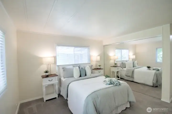 Primary bedroom with wall of closets - the mirrors make the room extra sunny and bright. Primary bedroom with wall of closets - the mirrors make the room extra sunny and bright.