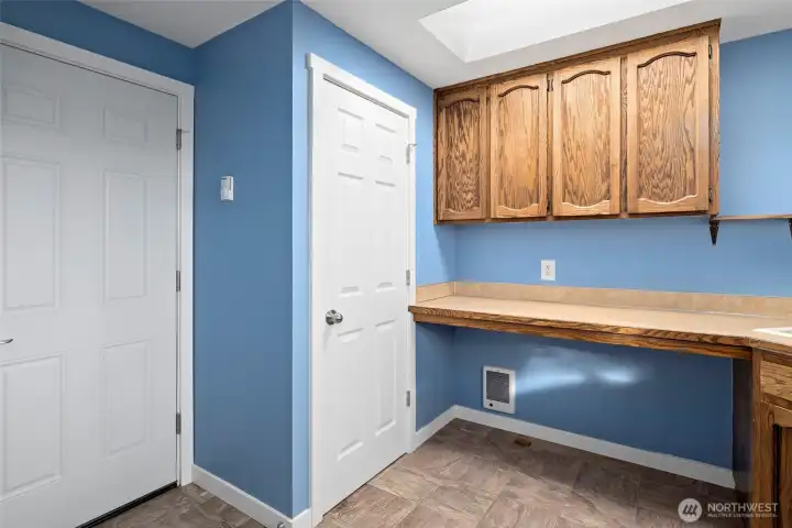 The other half of the laundry/craft room. The door on the left leads to the garage.